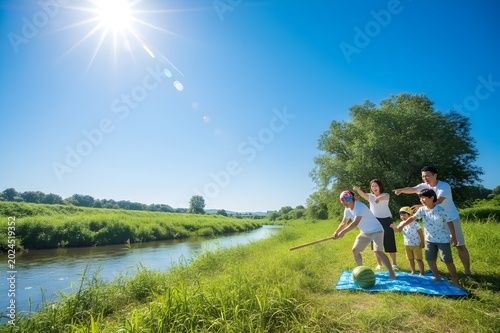 夏の河原で家族がスイカ割りを楽しむ日本の夏休みと思い出のアウトドアイメージ（AI生成）