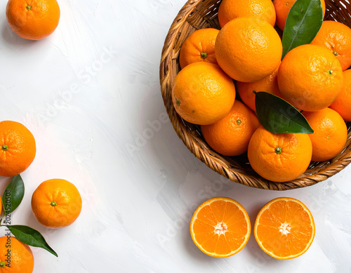 Fresh Oranges in a Wicker Basket with Sliced Halves on White Background.