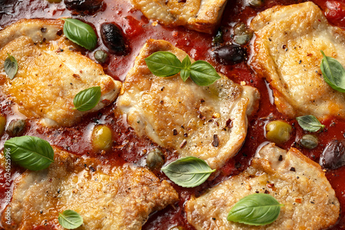 Chicken Puttanesca with capers, olives, tomatoes and anchovies. Italian food