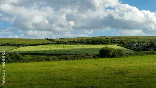 Tableau sur toile Light and Shadows over Field and Farmlands from a drone, Dorset, England