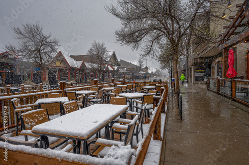 Spring snowfall on a restaurant patio in downtown Canmore, Alberta, Canada