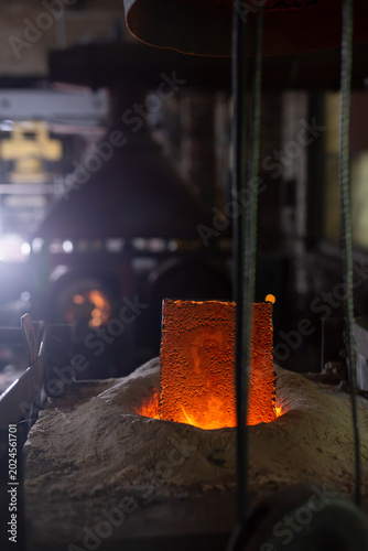 Foto Ferrous metal billet is melted in an induction furnace closeup