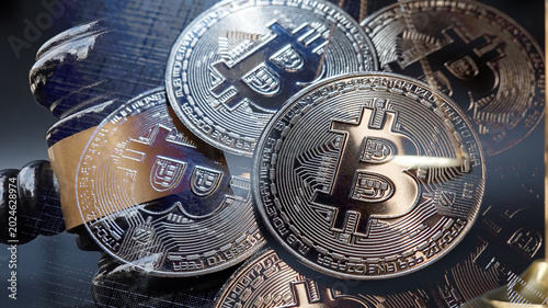Double exposure image of Bitcoin cryptocurrency coin combined with a judge gavel and scales of justices, Digital assets law, Blockchain compliance, financial risk, and crypto investment.