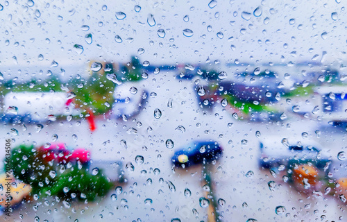 Fotografija Raindrops on window glass with blurred urban background