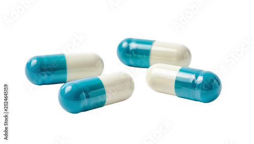 Photography Isolated group of four two-tone blue and white pharmaceutical capsules for healt