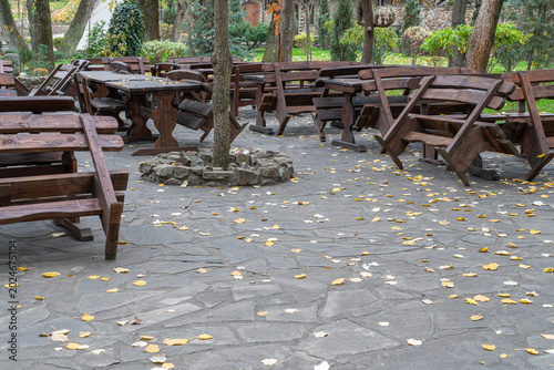 Outdoor seating area with wooden tables and chairs