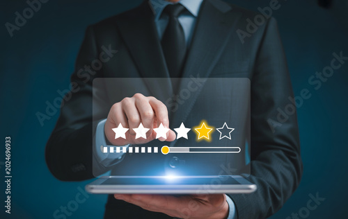 Businessman hand pointing five-star rating on virtual screen, customer feedback experience with satisfaction survey.