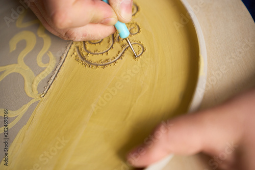 Obraz na płótnie Macro shot of tool tip creating relief patterns on a handmade ceramic object