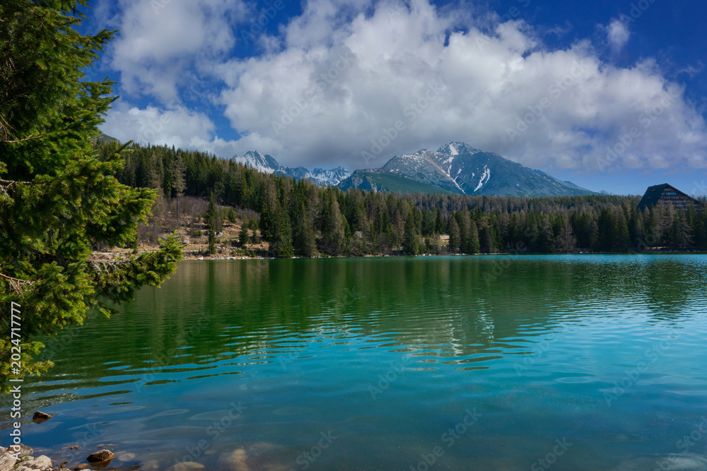 Fototapeta premium Scenic mountain lake reflection under blue sky. Štrbské Pleso High Tatras, Slovakia