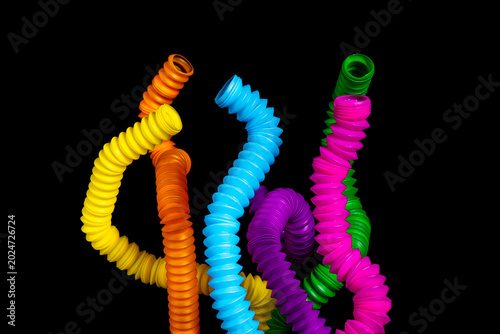 Obraz na plátne A colorful arrangement of stretchy ribbed colorful plastic flexible tubes agains