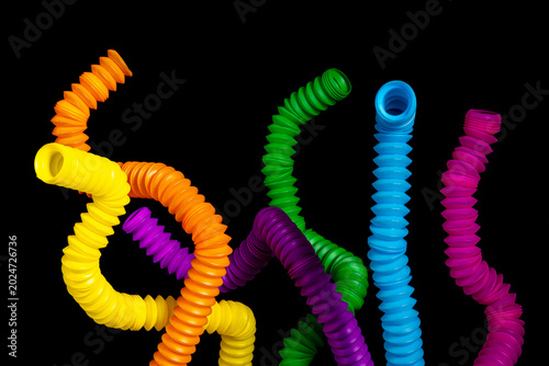 Картината върху платно A colorful arrangement of stretchy ribbed colorful plastic flexible tubes agains