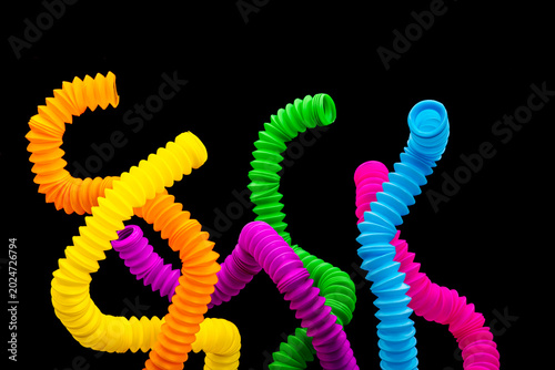 Quadro su tela A colorful arrangement of stretchy ribbed colorful plastic flexible tubes agains