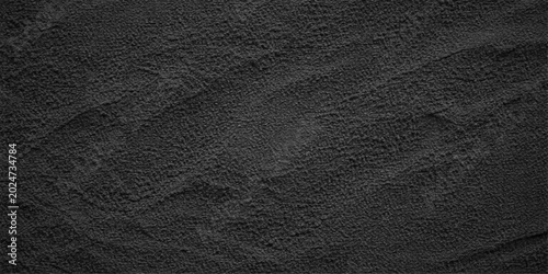A macro closeup of a dark, textured black leather and rough grey fabric material pattern, perfect for a grunge wall backdrop or natural textile design wallpaper surface