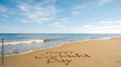 Happy canada day message written in sand on a beach Canada Day