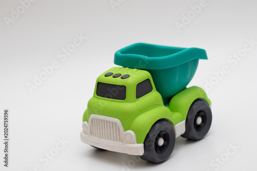 Children's toy truck green on a white background made of biodegradable plastic, bioplastics