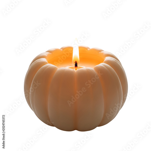 A small pumpkin shaped candle with a burning flame glowing softly for autumn and fall home decor isolated on transparent background
