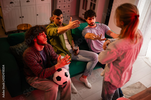 Bild auf Leinwand Friends preventing woman interrupting soccer game