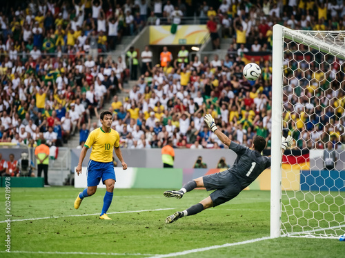 Footballer taking a powerful shot on the pitch