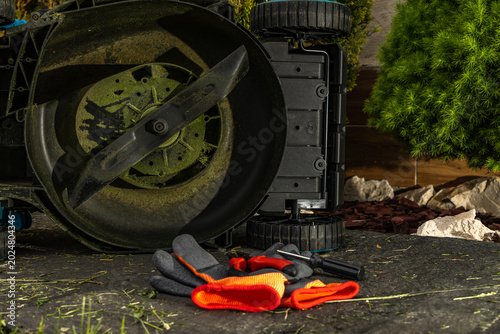 Fotografi Broken Lawn Mower in Garden During Repair and Maintenance Work
