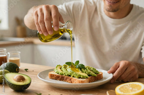 A Man Pouring Olive Oil on a Sandwich