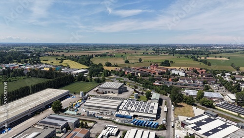 Obraz na plátne Aerial View of Industrial Park and Rural Landscape: An expansive aerial perspective showcases a sprawling industrial complex adjacent to cultivated fields and distant town