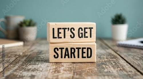 Wooden blocks with the text lets get started on a rustic wooden table