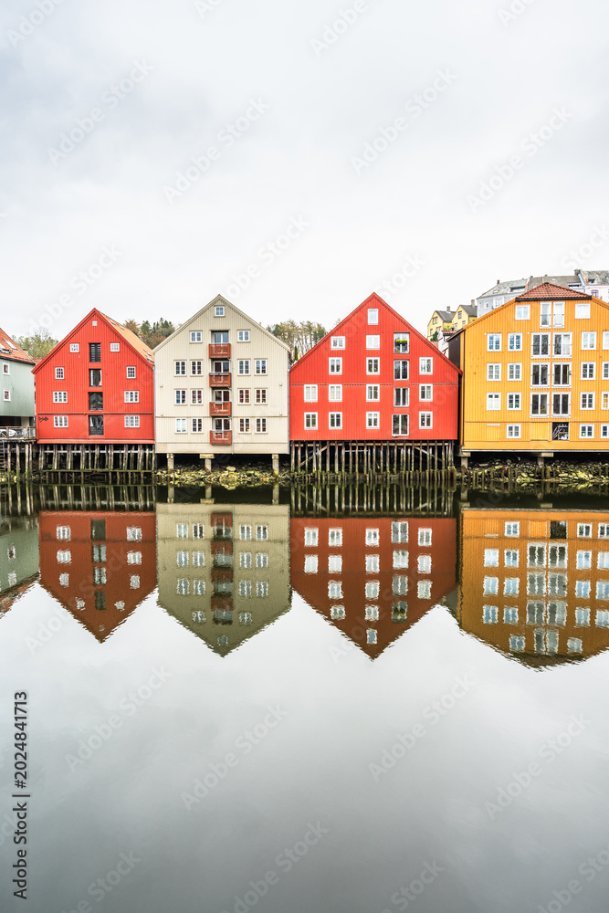 Fototapeta premium Colorful wooden houses on the banks of the Nidelva River in Trondheim