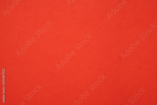 Solid red color background providing abstract texture for graphic design