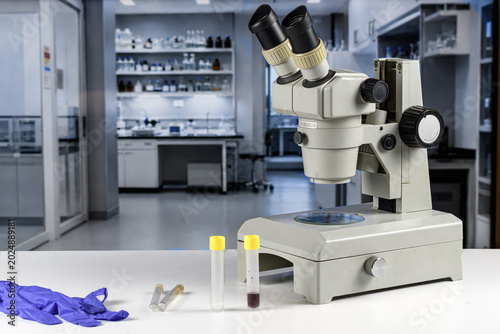 фотографія Microscope and Diagnostic Sample Tubes in Clean Virus Research Lab