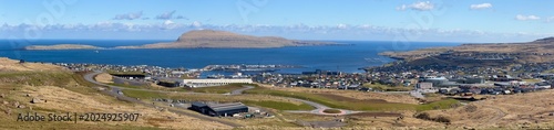 Panoramic view of the capital city Torshavn with colorful houses, historic Tinganes peninsula and Vagar island in the background, Streymoy, Faroe Islands