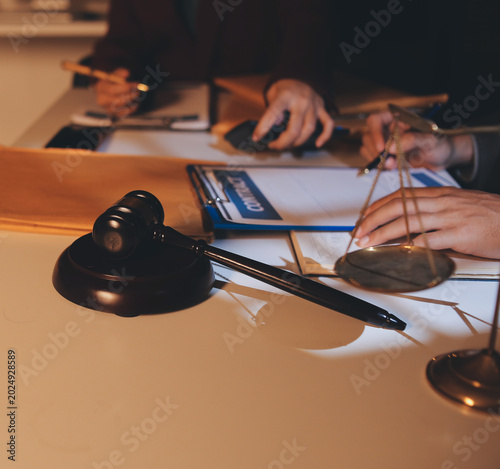 Close up of businessmen or lawyers discussing contract or business agreement at law firm office, Business people making deal document legal, justice advice service concept.