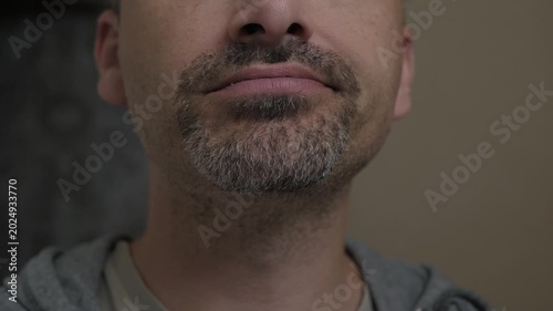 Close male portrait. Intimate male face study. Reflective image of man with gentle expressions. Detailed portrait highlighting subtle emotions and contemplative nature of man during routine moments
