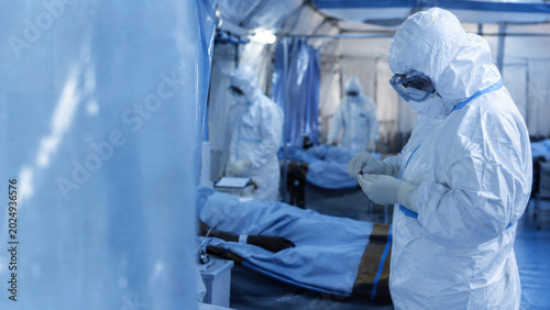 Ebola virus. Ebola virus healthcare response, medical team wearing full PPE in treatment facility