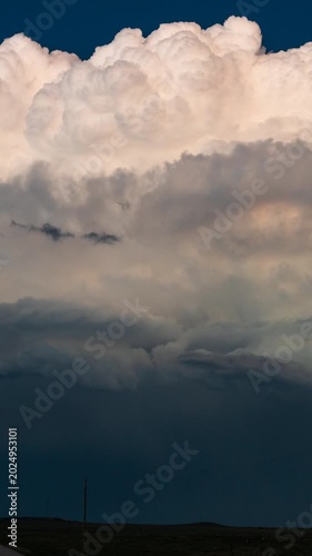 Thunderstorm clouds light up from within with frequent flashes of lightning