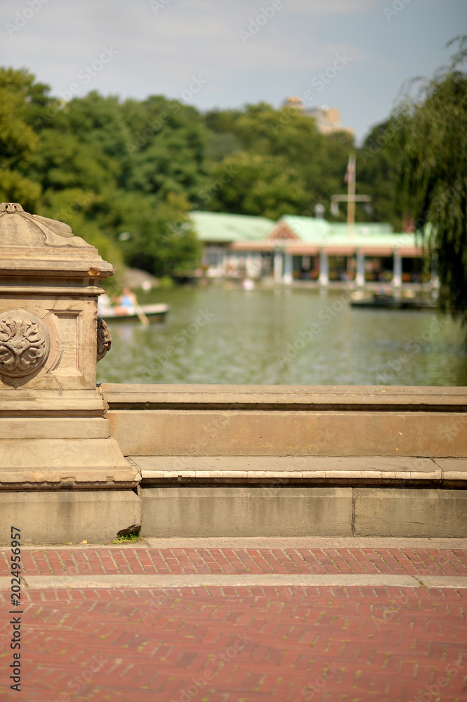 Obraz premium Serene Waterside With Trees. Tranquil Lakeside View With Boats And Sunlight new york
