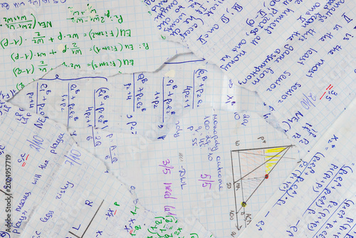 Collage of torn blue graph paper scraps with handwritten mathematical formulas and notes. Abstract education background for scrapbooking, study themes, school design, creative paper texture