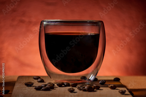 Close-up of a glass cup with black coffee.