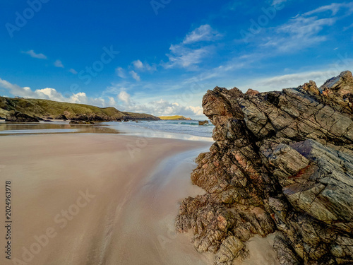 Natural Rock Structures With Textured Sand And Atmospheric Maritime Background