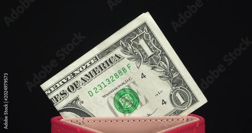1 dollar banknote, USD. One US dollar in a red wallet. American dollar. Red wallet with single USD note. Cash, finance, savings, wealth, taxes