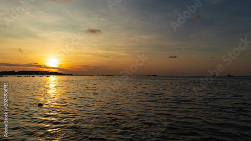 A beautiful sunset on the beach of Belitung Island, Indonesia. A warm and comfortable atmosphere during the summer holidays.