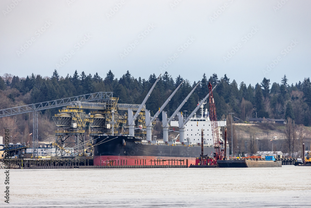 Fototapeta premium Bulk Cargo Ship Docked at Industrial Port on Fraser River in Vancouver, BC, Canada