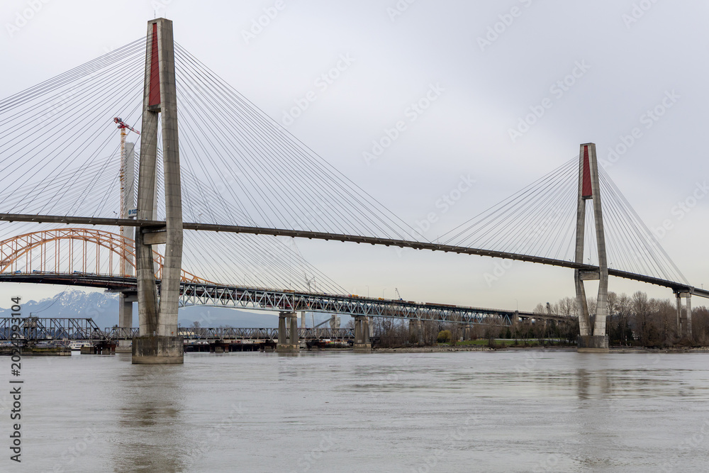 Fototapeta premium Cable-Stayed Bridge Over River With Concrete Pylons Near New Westminster, Vancouver, BC