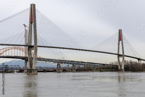 Fotografie Cable-Stayed Bridge Over River With Concrete Pylons Near New Westminster, Vancou