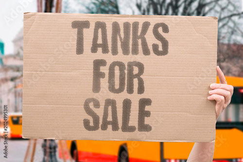 Tableau sur toile "Tanks For Sale" Heavy military equipment shipped across borders fuels ongoing distant conflicts