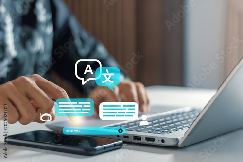 Businessman using laptop and smartphone with digital language translation interface icons. Language translation, global communication, multi-lingual localization, cultural connectivity, AI chatbot