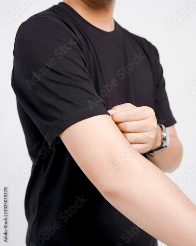 Faceless man's arm in black t-shirt in front of white background