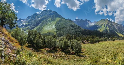 Photos Valley in the Caucasus Mountains, rocky peaks, green slopes and blue sky