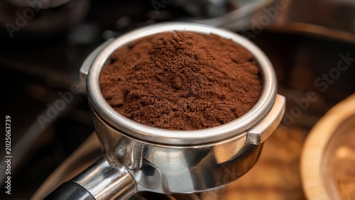 portafilter. Close-up of fresh ground coffee in a portafilter, coffee brewing preparation. bar promotions, beverage menus, designed for food & beverage menus and cafe branding, inspires menu design.