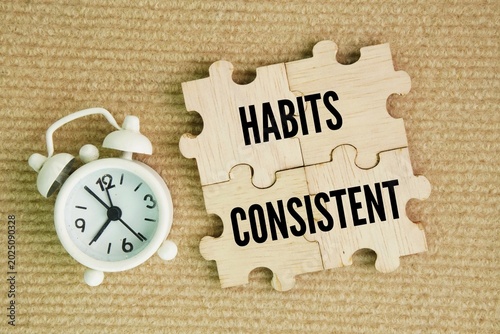 Cuadro en lienzo Wooden puzzle with word Habits and Consistent