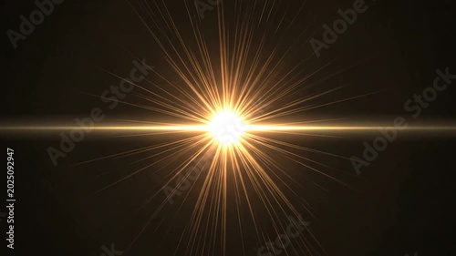 A bright golden light flare radiates from the center of a dark background
